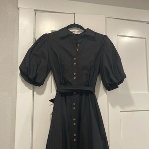Women’s midi black dress with puffer sleeves.